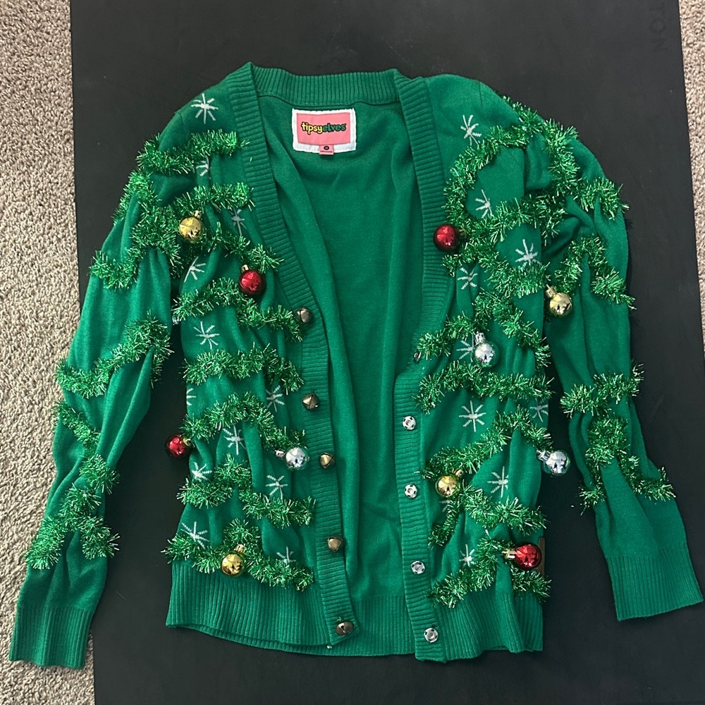 Festive Green Tipsy Elves Sweater with Holiday Decorations
